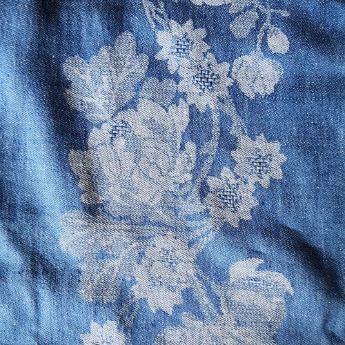 Aegean blue cotton tablecloth with floral woven patterns and lace trim