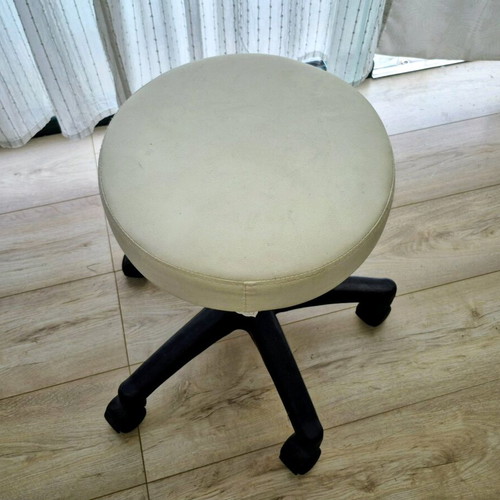 Rolling stool used with adjustable height and white leatherette