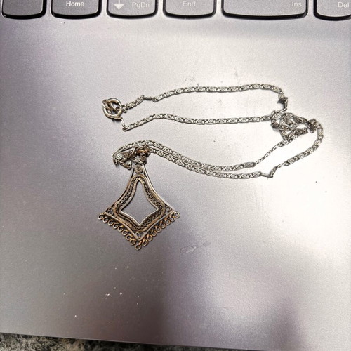 Silver vintage pendant with intricate chain