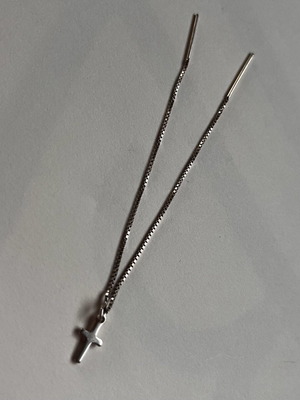 Silver hanging cross earring used for multiple piercings
