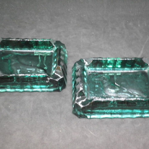Antique ashtrays pair used with embossed dogs in dark green glass
