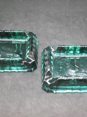 Antique ashtrays pair used with embossed dogs in dark green glass