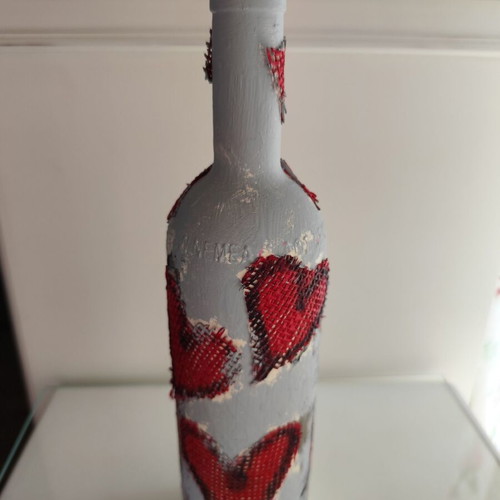 Glass bottle new with decoupage decoration and red hearts