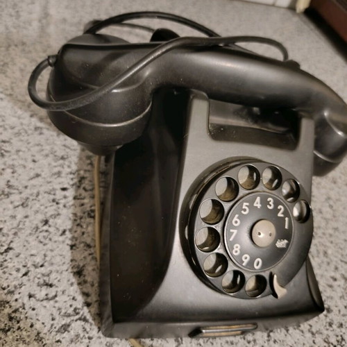 Vintage telephone used, black bakelite with rotary dial