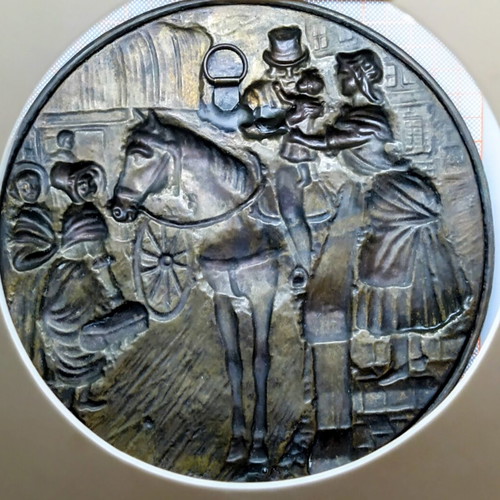 Vintage round brass plate used with embossed scene