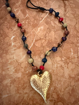 Faux necklace like new, long with gold metal heart pendant