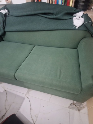 Two-seater sofa bed like new with green fabric upholstery