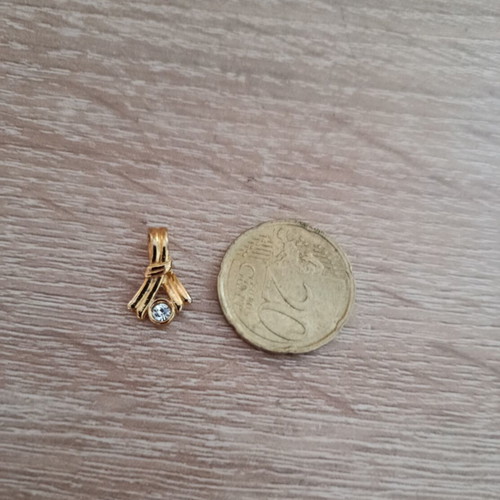 Gold-colored pendant with white stone used, vintage style