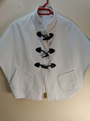 White short cape poncho used with leather toggle fastenings, one size