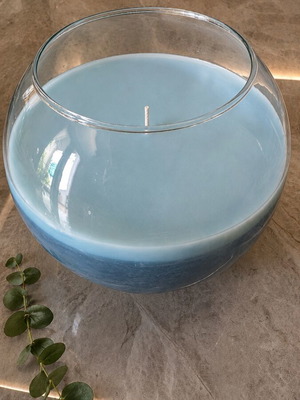 Large blue scented candle in glass