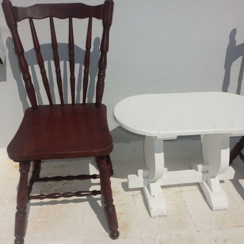 Wooden set with oval white table and 2 traditional dark chairs used for outdoor