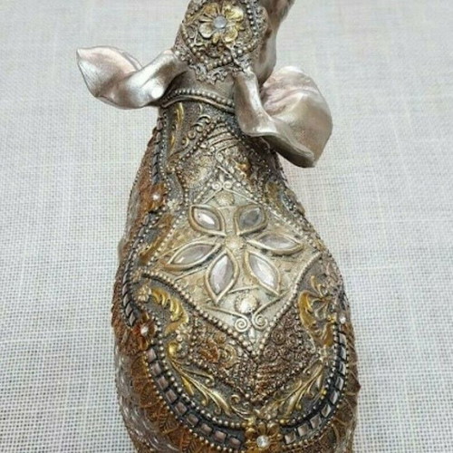 Handmade wooden elephant used with decorations and crystals