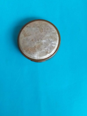 Antique powder compact used with metal bronze casing