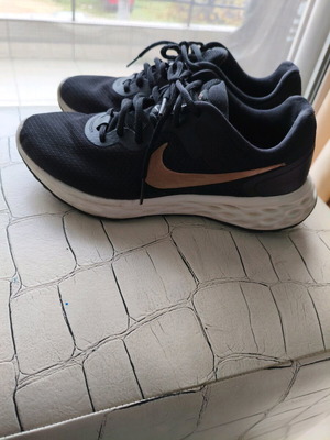 Nike shoes size 38.5 used, black with gold logo, athletic