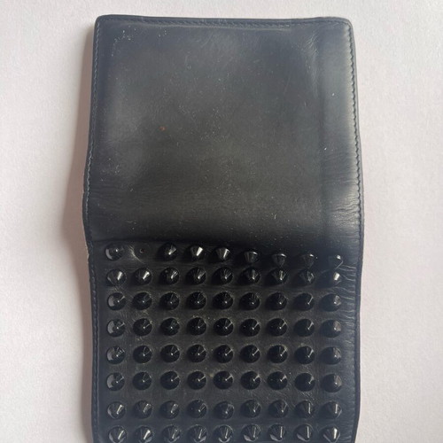 Christian Louboutin wallet used with missing spike and black stains