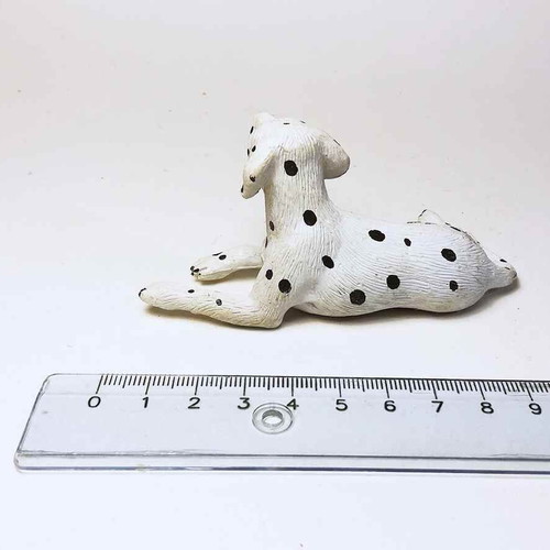 Plastic dog figure used with scratches and marks