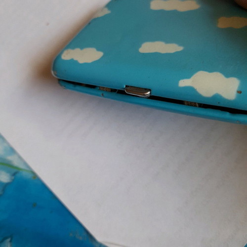 Tobacco case used, sky blue with white smoke clouds