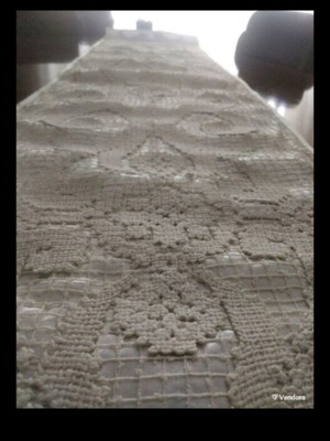 Table runner with intricate handmade lace and satin backing