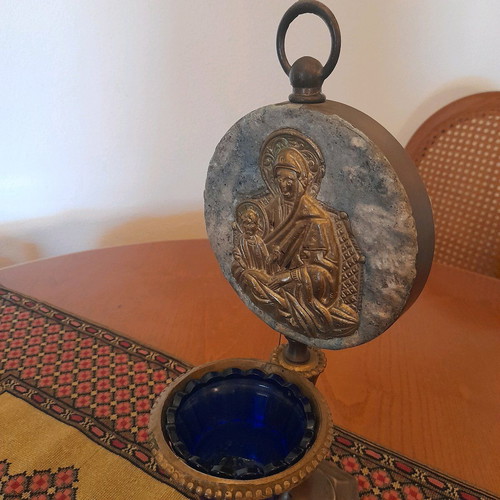 Bronze religious lamp used with embossed Virgin Mary image on stone base