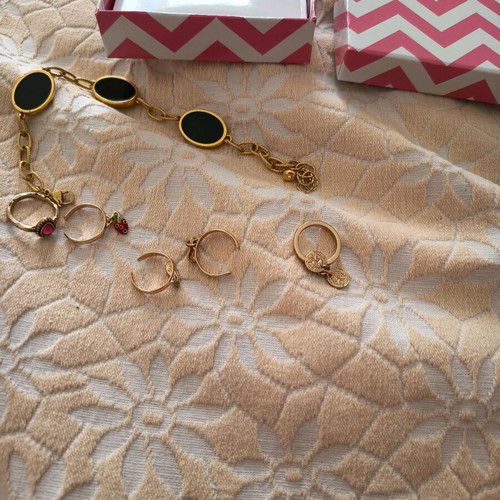 Jewelry set used with bracelet and five gold-colored rings