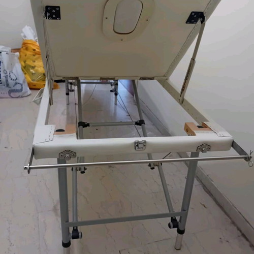 Massage bed like new, white with nickel base and folding feature