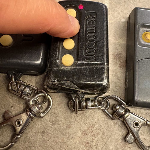 Garage door remotes used, set of 10, one broken with tape