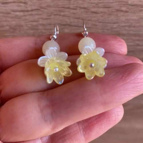 Handmade earrings with yellow and white beads and silver metal details
