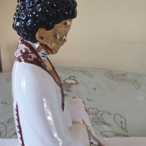 Vintage porcelain Buddha statue with gold details
