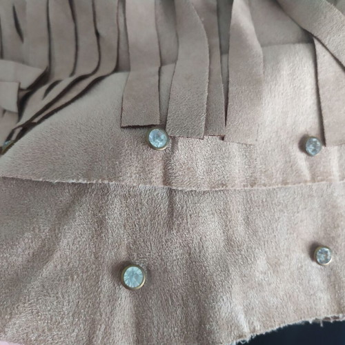 Skirt used with suede-type fringes and matte antique gold details