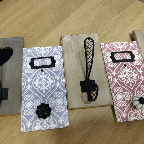 Decorative wall hanger used with wooden base and metal hooks