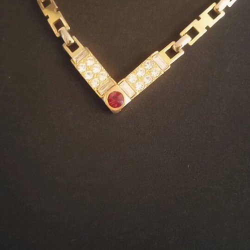 Necklace like new, gold color with white and red stones