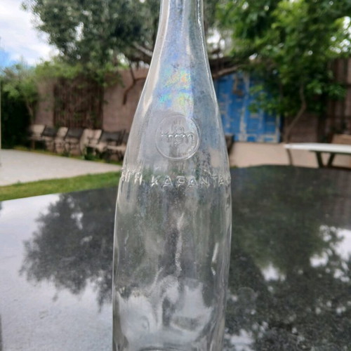 Glass bottle used with embossed HBH Karantani logo