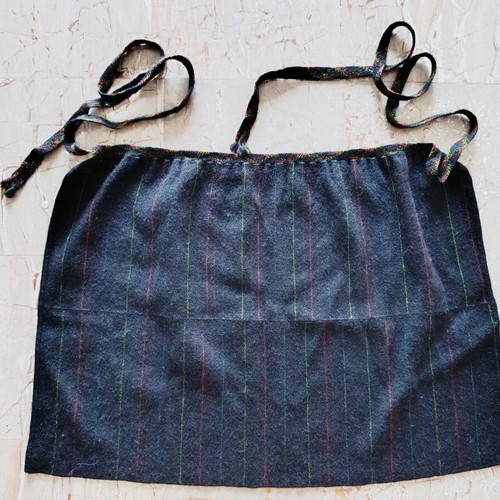 Traditional black apron with vertical stripes used
