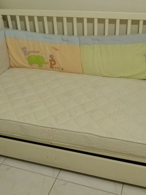 Children's cot-bed used with mattress and storage space