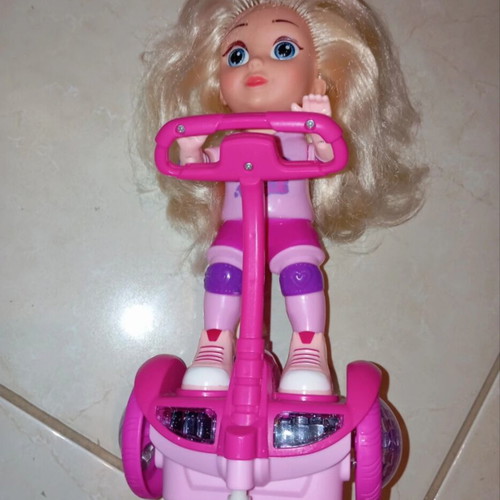 Doll on electric scooter with songs and lights, like new