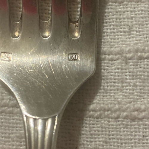 Vintage silver-plated food fork used with embossed decoration