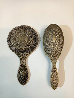 Brass hand mirror and brush set used with carved designs