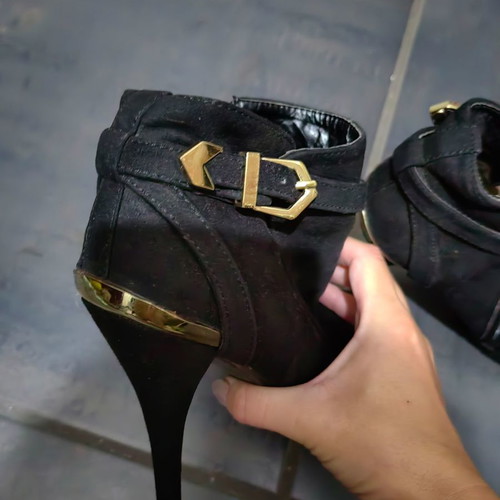 High-heeled ankle boot used, black with gold details