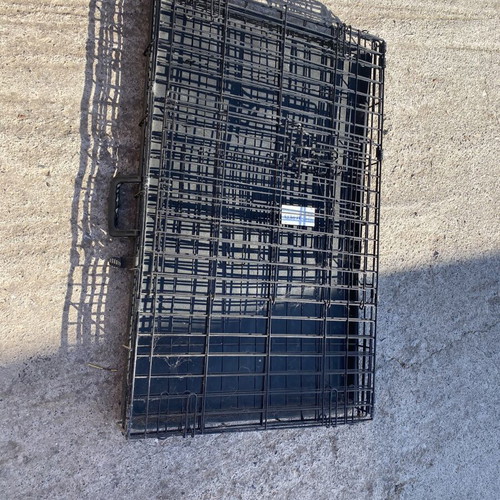 Dog crate used for a large dog with two doors and cleaning tray