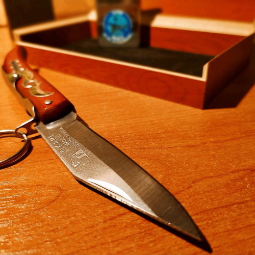 Collectible Zippo lighter 32 years old and handmade Okapi knife.