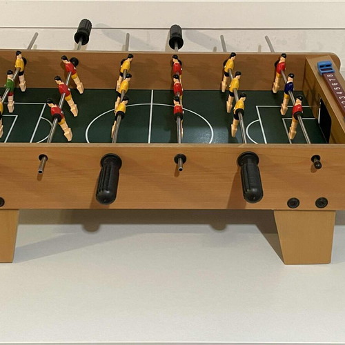 Children's foosball table used without balls and missing one handle