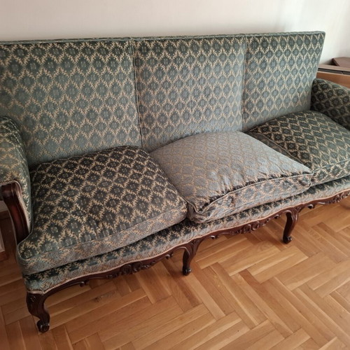 Vintage three-seater sofa and two antique armchairs with dark wood frame
