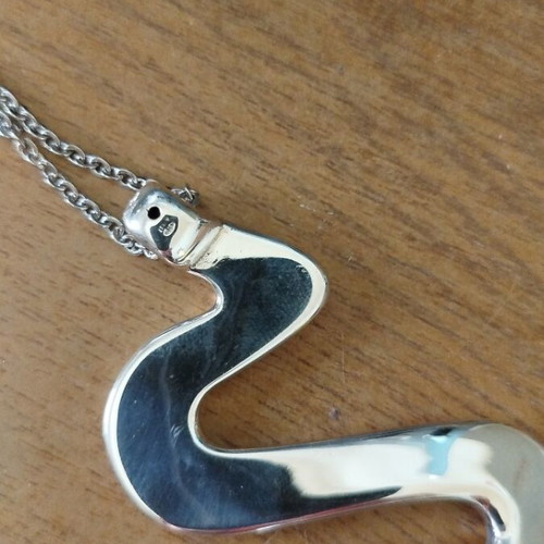 Silver necklace with wave-shaped snake pendant like new