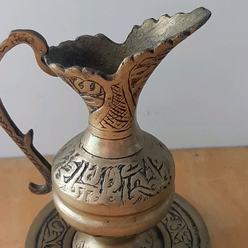 Oriental solid brass pitcher used with saucer