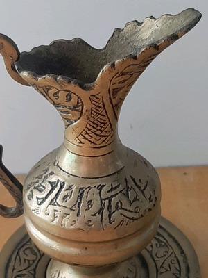 Oriental solid brass pitcher used with saucer