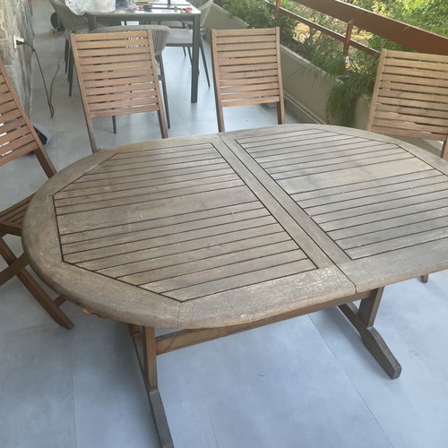 Wooden balcony table with four chairs used