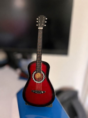Decorative miniature guitar used, red with stand