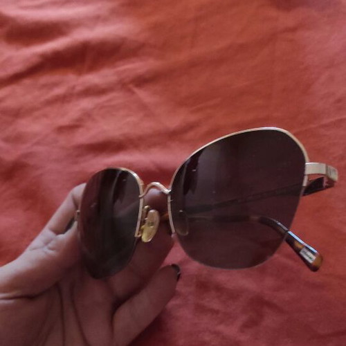 Sunglasses used with wear and gold arm