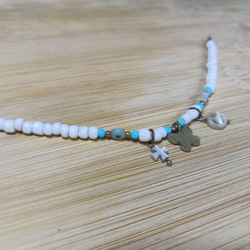 Bracelet with blue and white beads, peace sign and charms