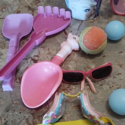 Beach items used, pack with masks, rackets, balls, bucket, sunglasses